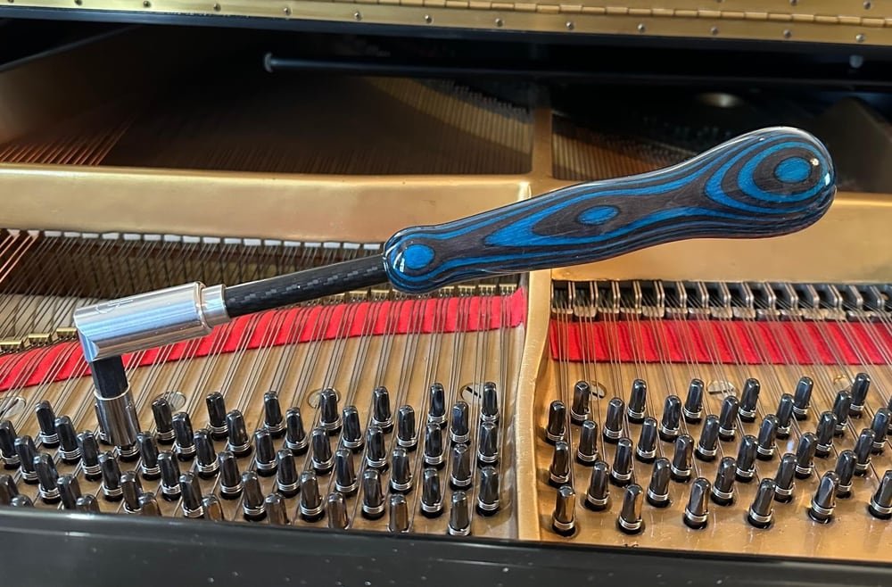 Piano tuning lever positioned inside a grand piano